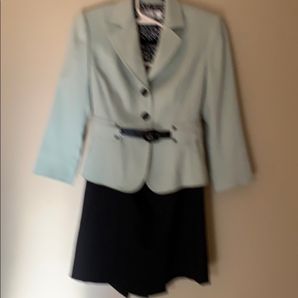 Lt green jacket and black skirt.